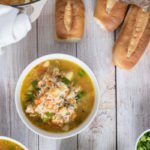 Flat photo of bowls of chicken and rice soup and salt bread