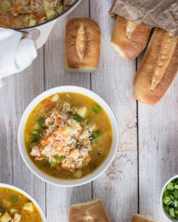 Flat photo of bowls of chicken and rice soup and salt bread