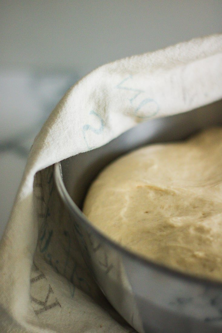 Dough resting in a metal bowl.
