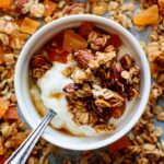 a white bowl of yogurt and granola