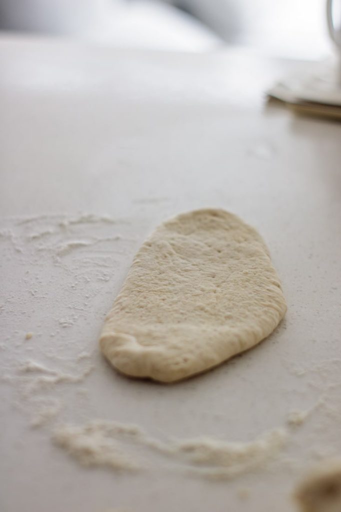 flat dough on floured surface just before shaping