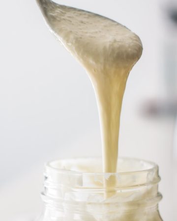 culture being lifted from jar with the help of a spoon