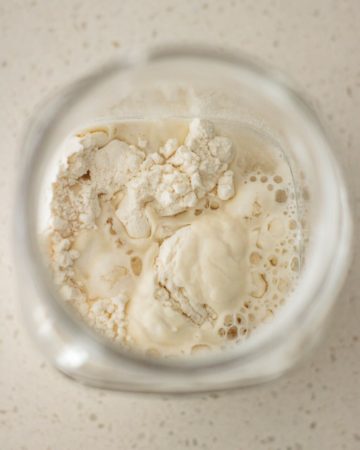 flour and water being mixed inside jar