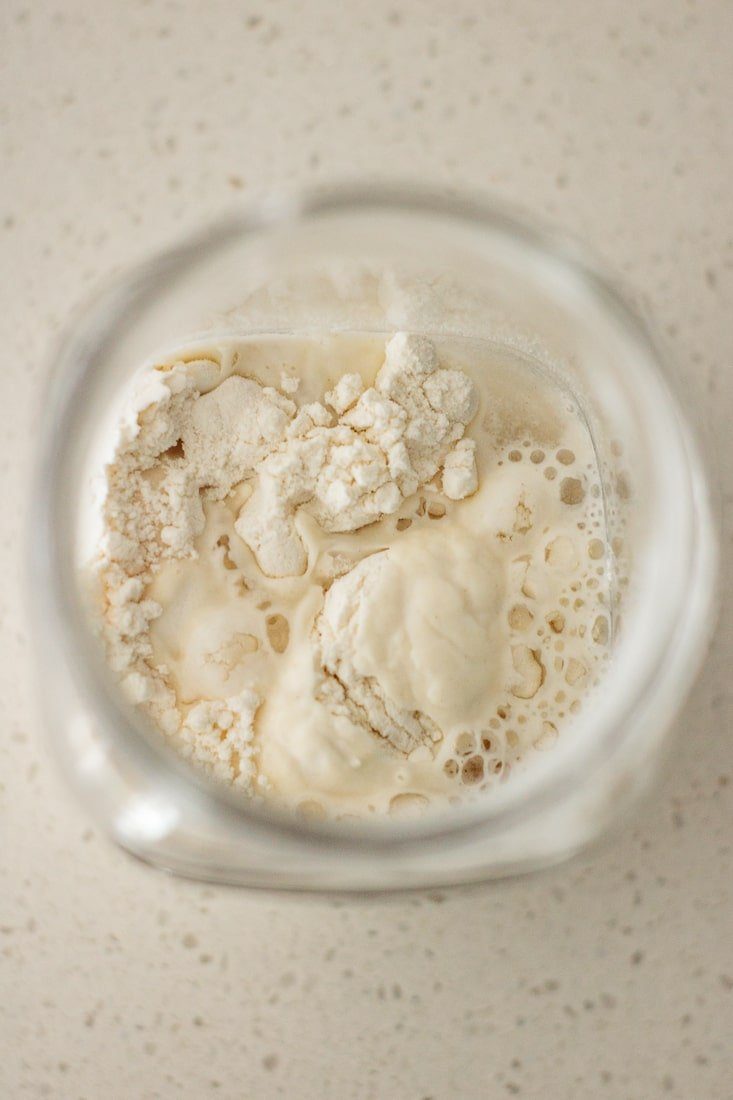 flour and water being mixed inside jar