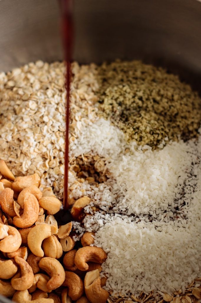 coconut sugar syrup being poured in the dry ingredients