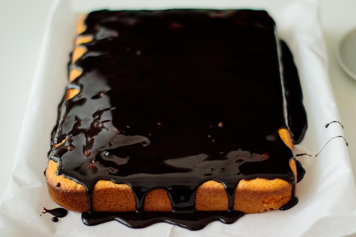 whole brazilian carrot cake topped with shiny chocolate glaze