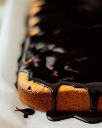 close up on sheet cake with drizzling chocolate glaze