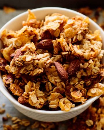 white bowl full of baked cornflakes cereal granola