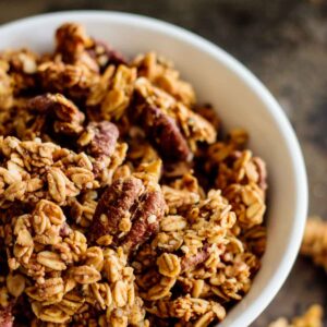 a with bowl of baked pumpkin spice granola