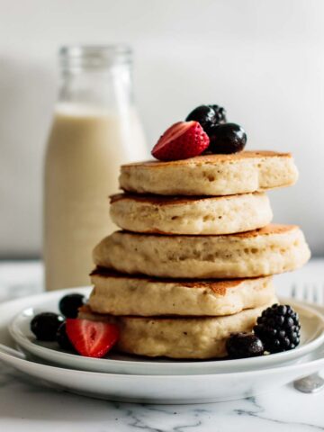 a stack of sourdough pancakes with berries
