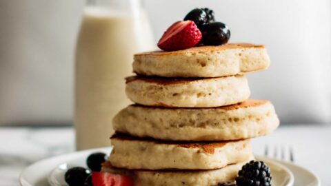 a stack of sourdough pancakes with berries