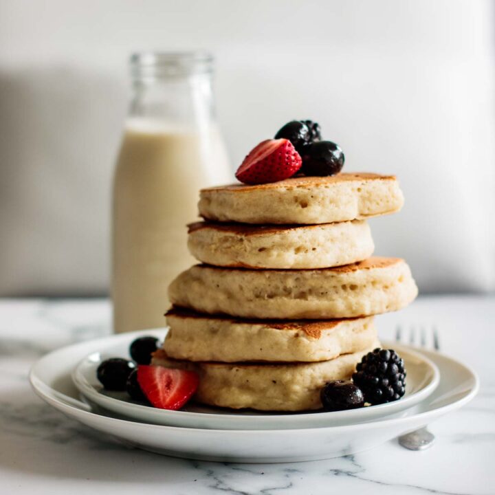 a stack of sourdough pancakes with berries
