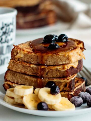 sourdough french toast with butter, berries, bananas and maple syrup