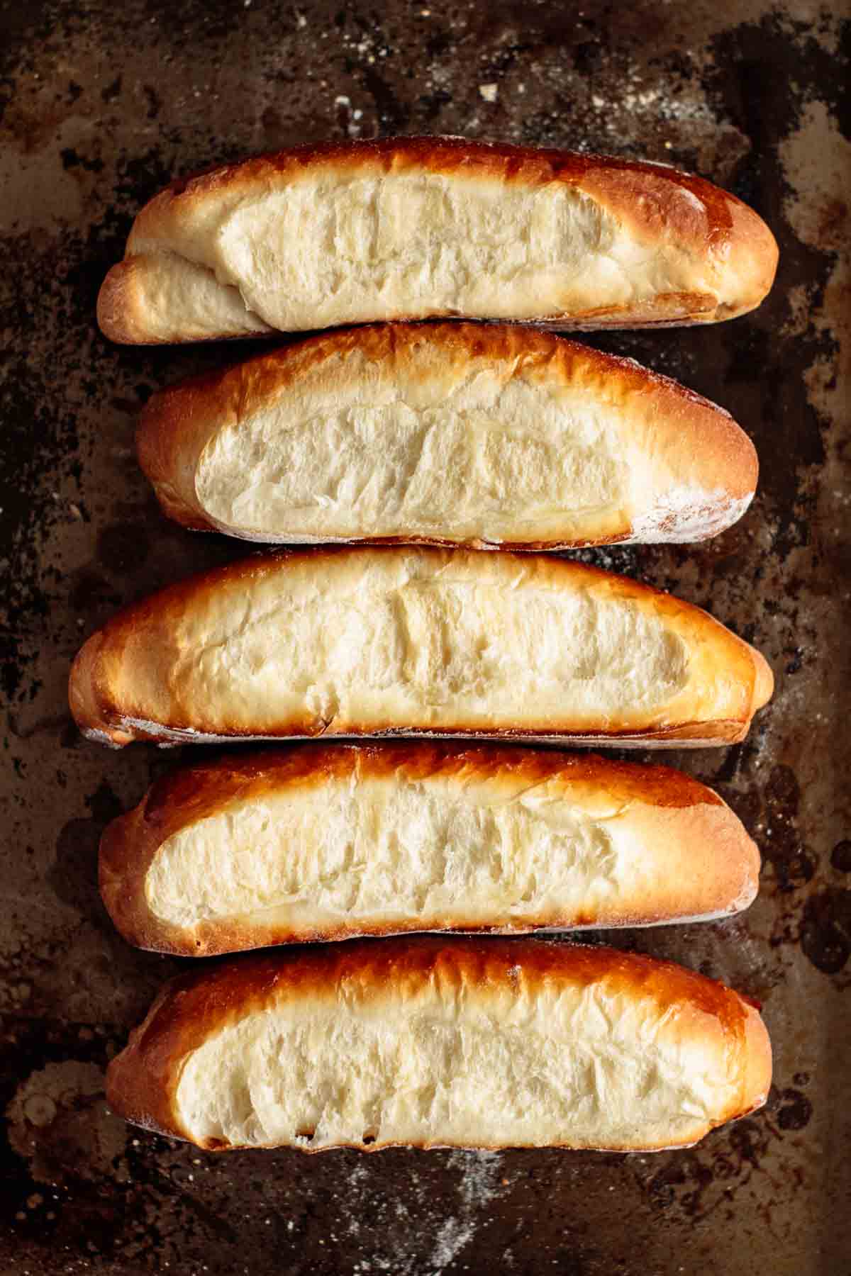 fresh hot dog buns on a baking sheet