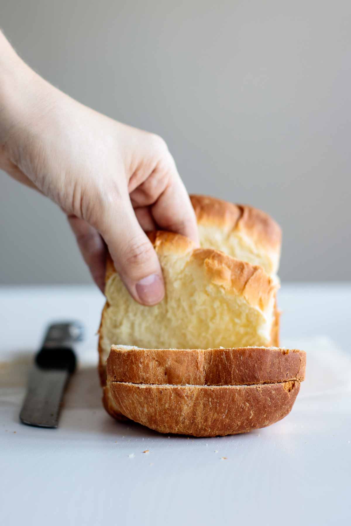 hand grabbing a slice of bread