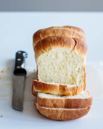 japanese milk bread, sliced, with bread knife on its side