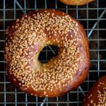 golden brown sourdough bagel with sesame seeds