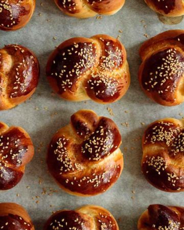 baked challah rolls over lined baking sheet