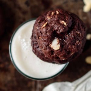double chocolate almond cookie on top of a glass milk
