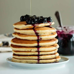 pancakes made with almond milk topped with blueberries and maple syrup