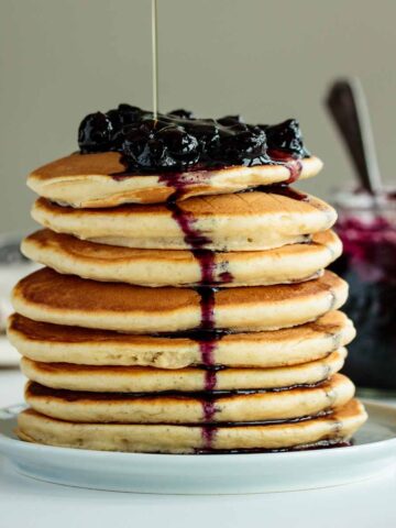 pancakes made with almond milk topped with blueberries and maple syrup
