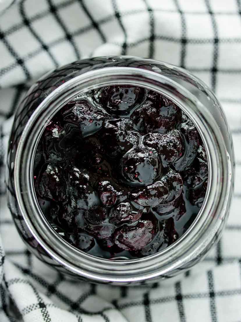 Blueberry compote in a glass jar.