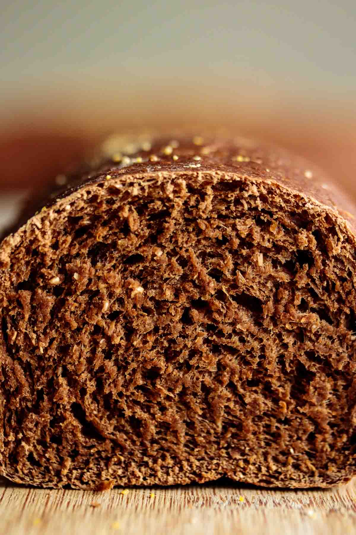 Close up showing chewy brown crumb of a sliced roll.