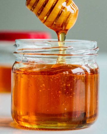 vegan honey dripping off a honey dripper