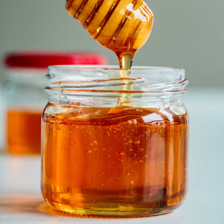 vegan honey dripping off a honey dripper