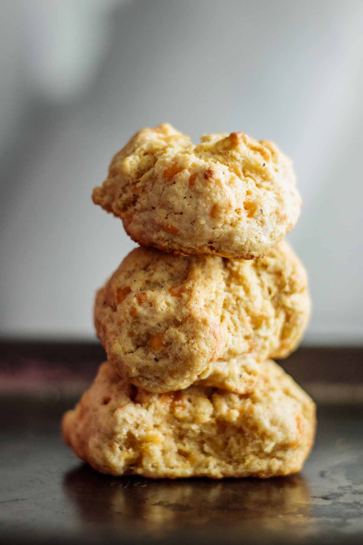 A stack of 3 cornmeal biscuits.