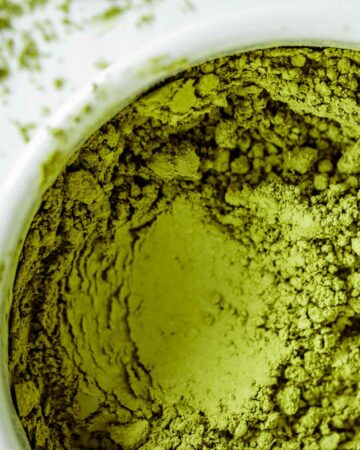 Vibrant green Matcha powder close up, showing its texture.