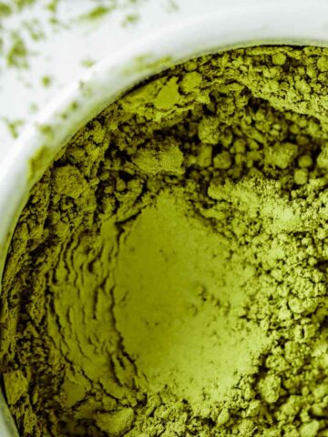 Vibrant green Matcha powder close up, showing its texture.