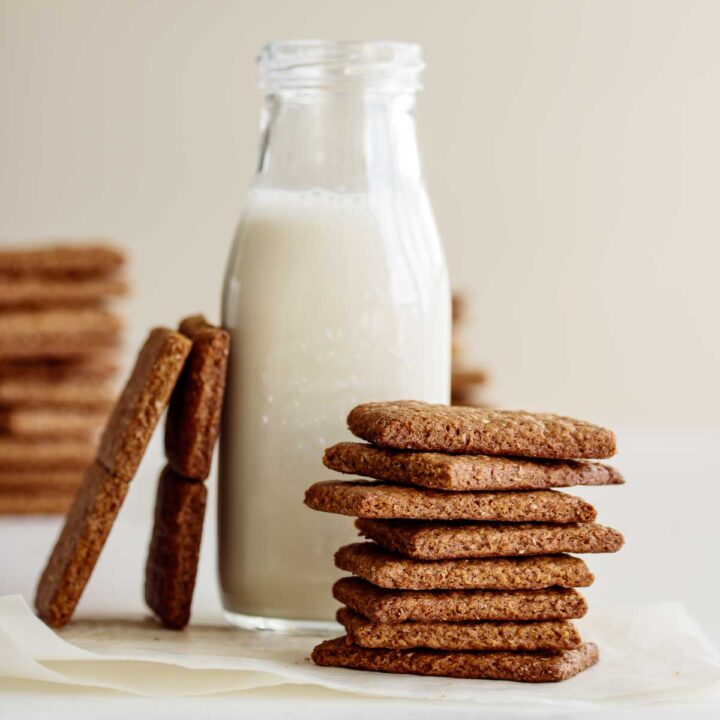 A stack of vegan graham crackers and a bottle of oat milk.