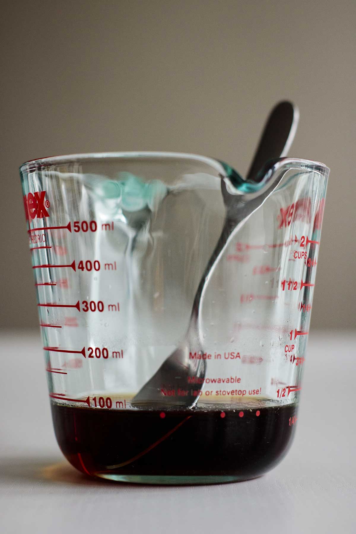 Brown sugar syrup inside a heat proof measuring cup.