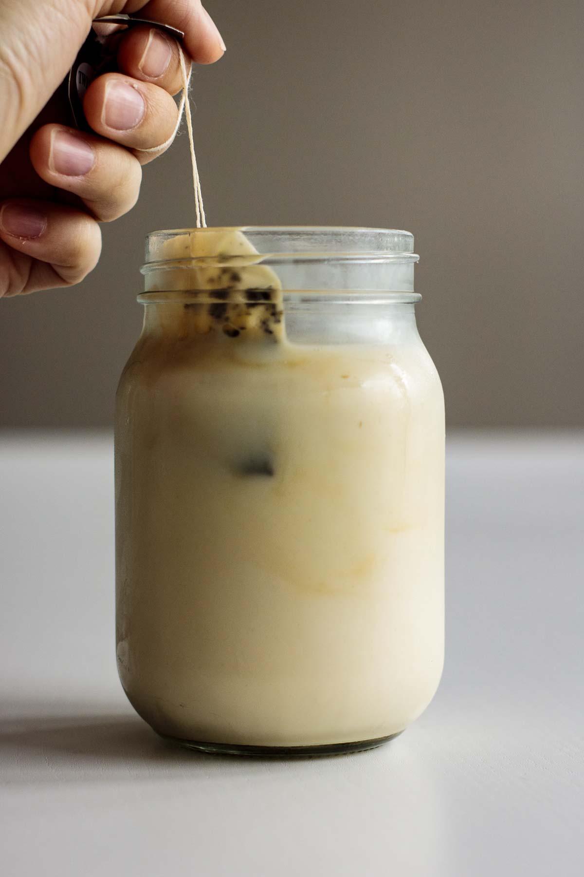 Tea bags being removed from cold brew milk tea.