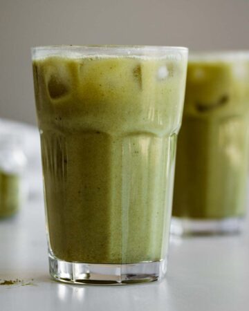 Two glasses of pineapple matcha drink.