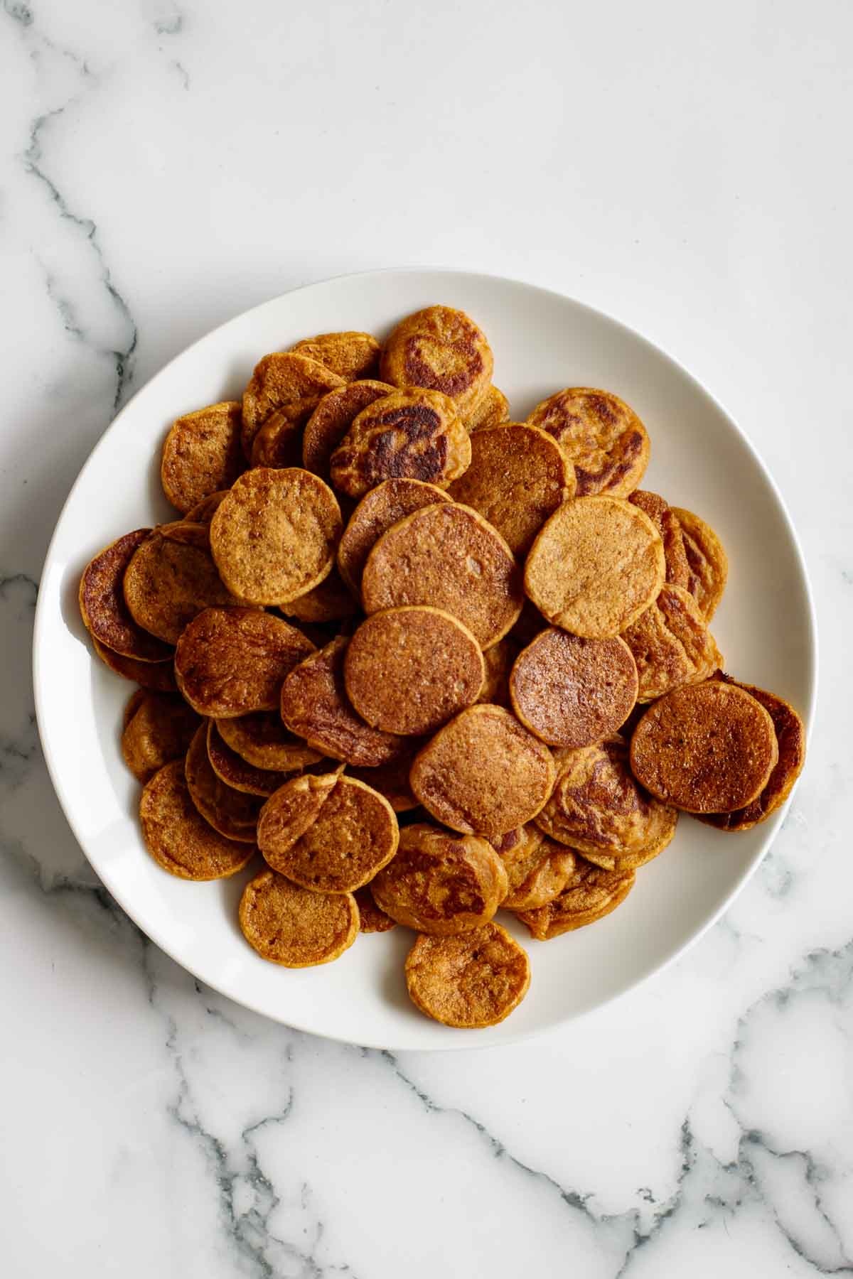 A plate with pumpkin cereal pancakes.