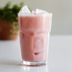 A glass of guava passionfruit drink.