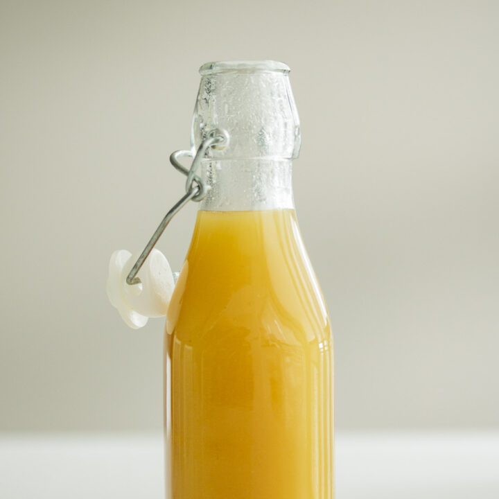 Pineapple ginger syrup in a bottle.