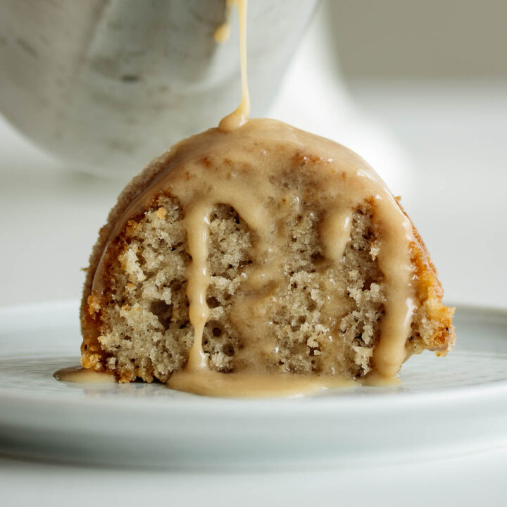Slice of earl grey cake with pouring glaze.