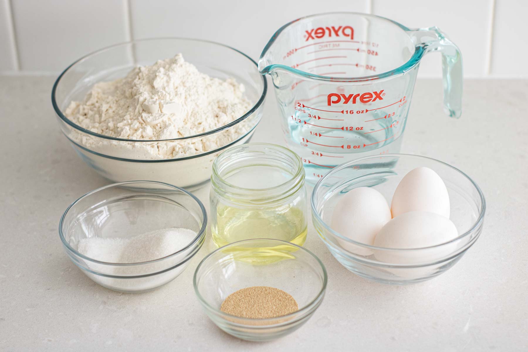 Ingredients of a challah bun: sugar, salt, oil, yeast, flour, eggs and water.