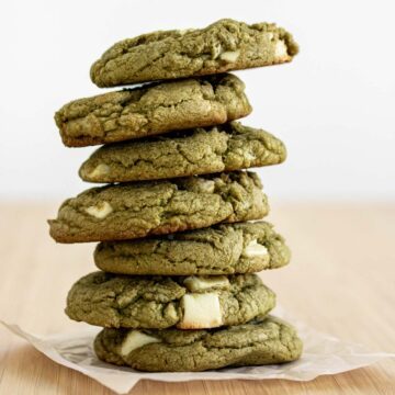 Matcha white chocolate chip cookies over parchment paper.