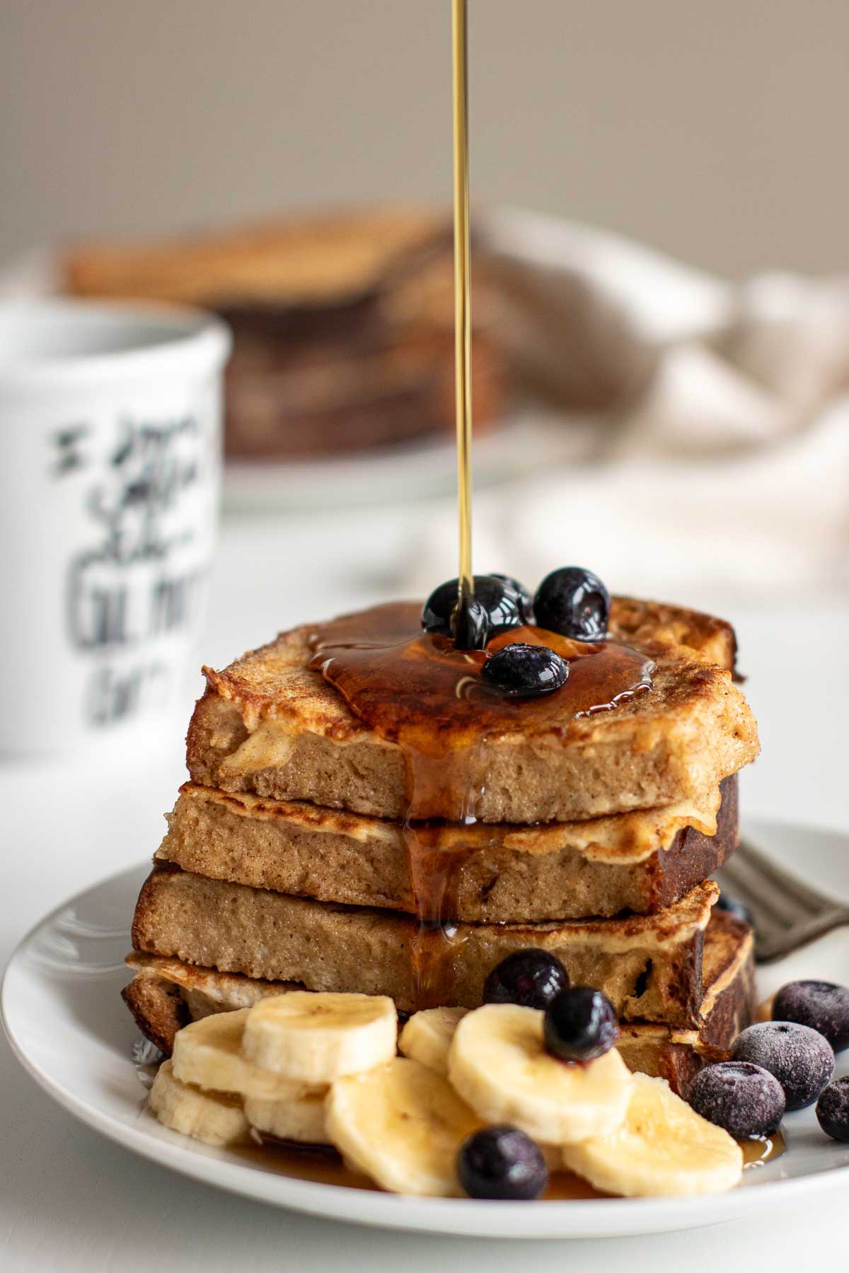 Sourdough French toast with maple syrup and fruits.