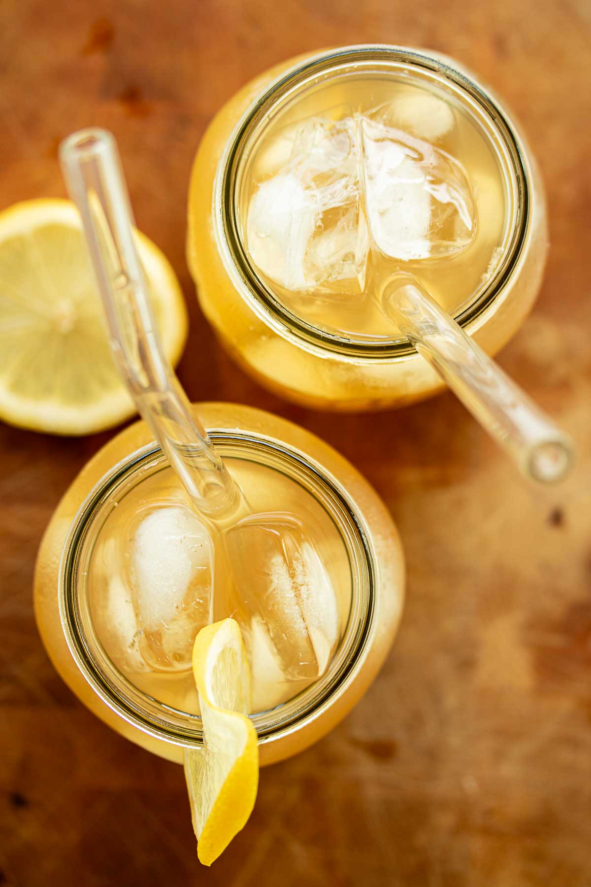 Lemonade from above, with glass straws and lemons slices decorating.