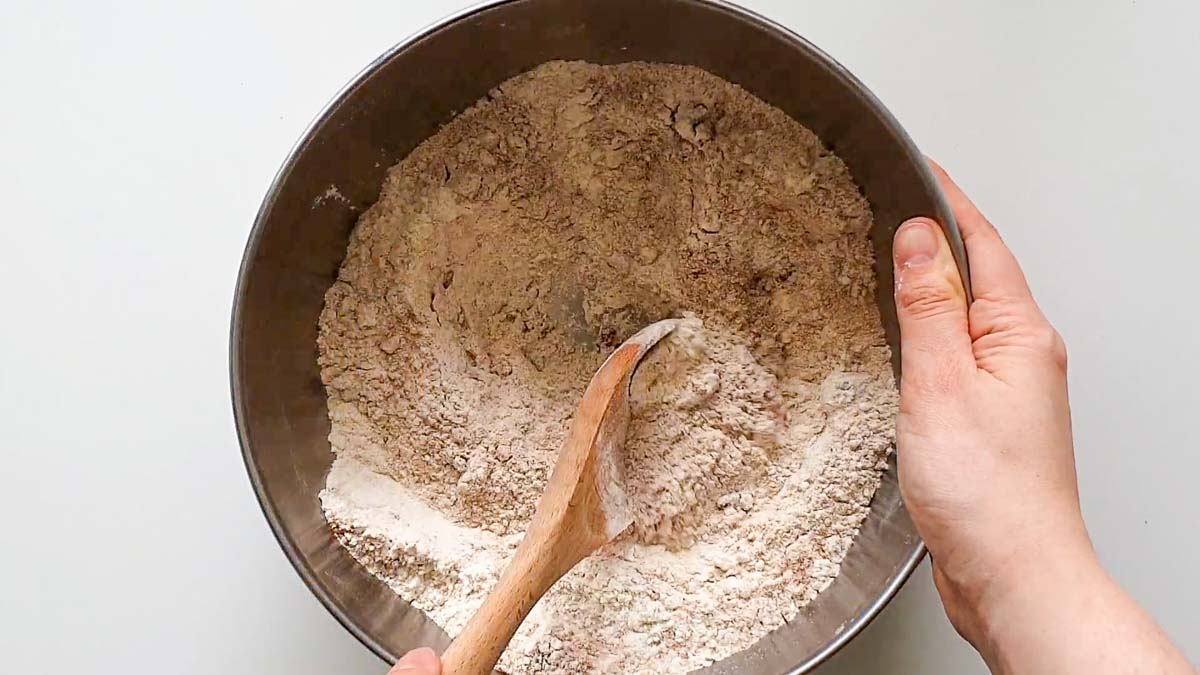 Spoon mixing dry ingredients in a bowl.