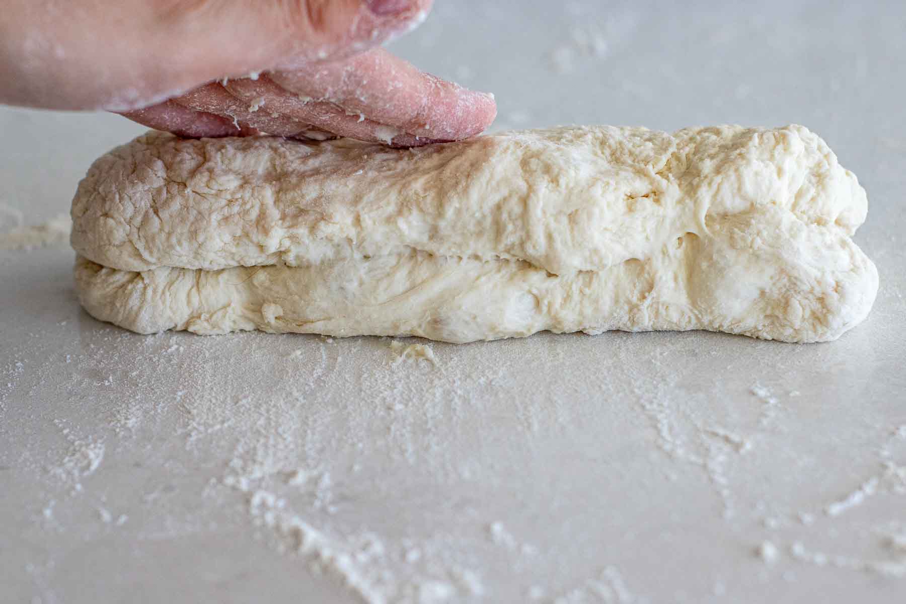 Folding the dough in the middle.