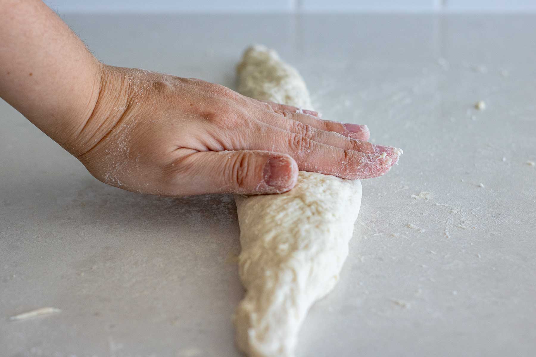 Hand rolling the dough.