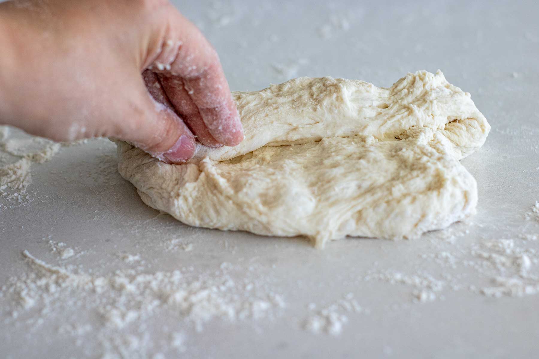 Pinching dough closed after folding.