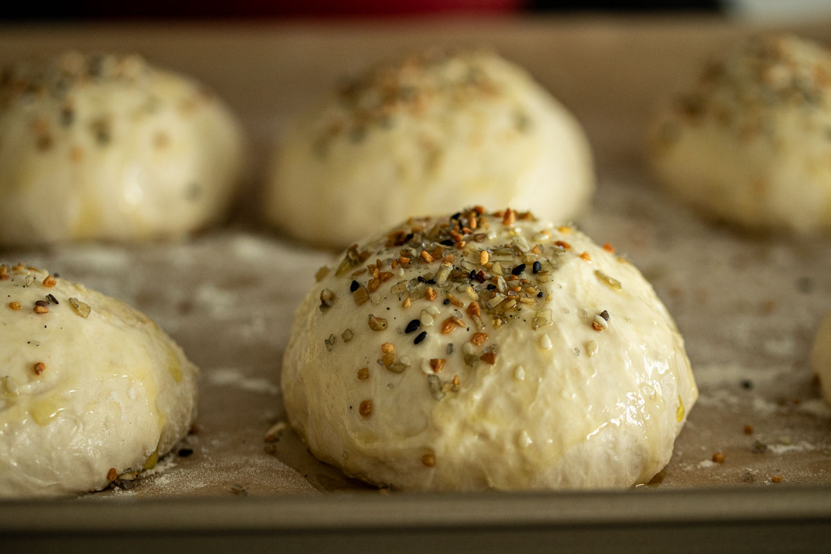 Rolls brushed with olive oil and with seasoning at the top.