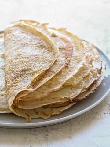 A stack of sourdough crepes, folded in half.